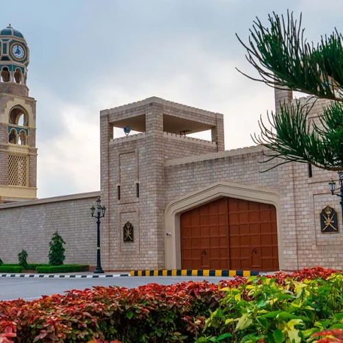 Al Hosn Palace in Salalah behind palm trees