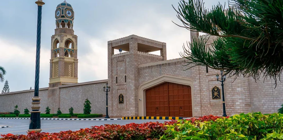 Al Hosn Palace in Salalah behind palm trees