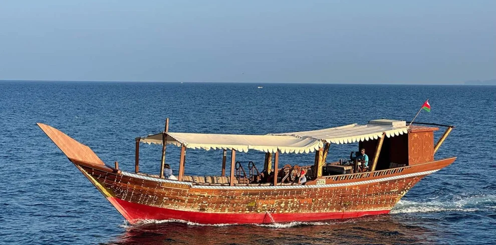 A traditional wooden dhow on calm blue water