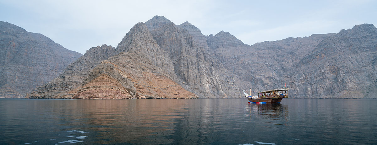 A dhow on a hazy day in the fjords of Musandam