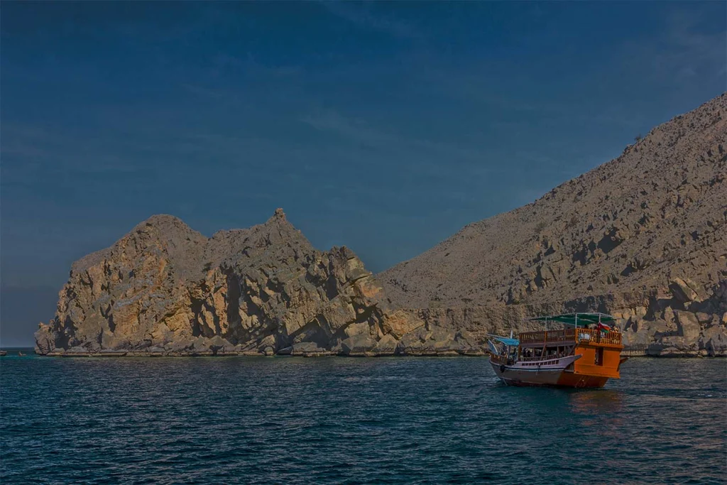 A dhow in a Musandam fjord in the evening light