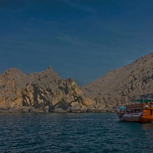 A dhow in a Musandam fjord in the evening light