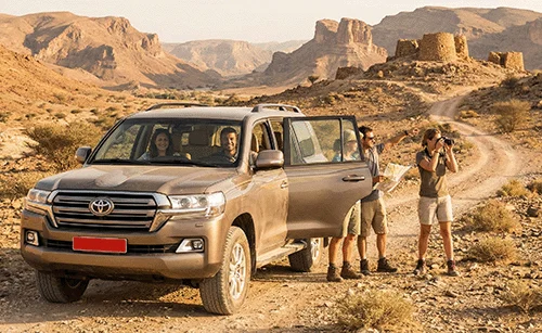 Travellers beside their 4x4 on a mountain track