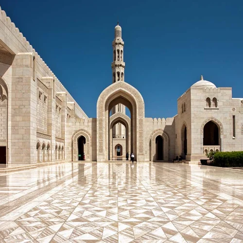 Marble arcades and the minaret of the Sultan Qaboos Grand Mosque