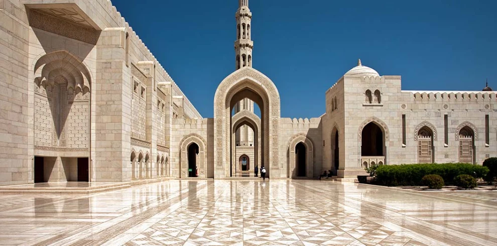 Marble arcades and the minaret of the Sultan Qaboos Grand Mosque