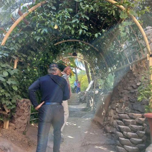 A path under a green archway in Misfat Al Abriyeen