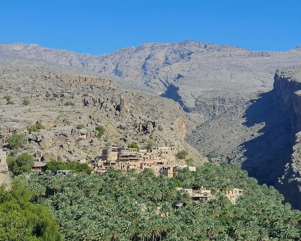 Misfat Al Abriyeen village among palms in a mountain valley