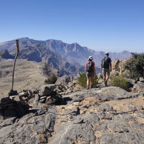 Hikers on a high ridge path among rocks
