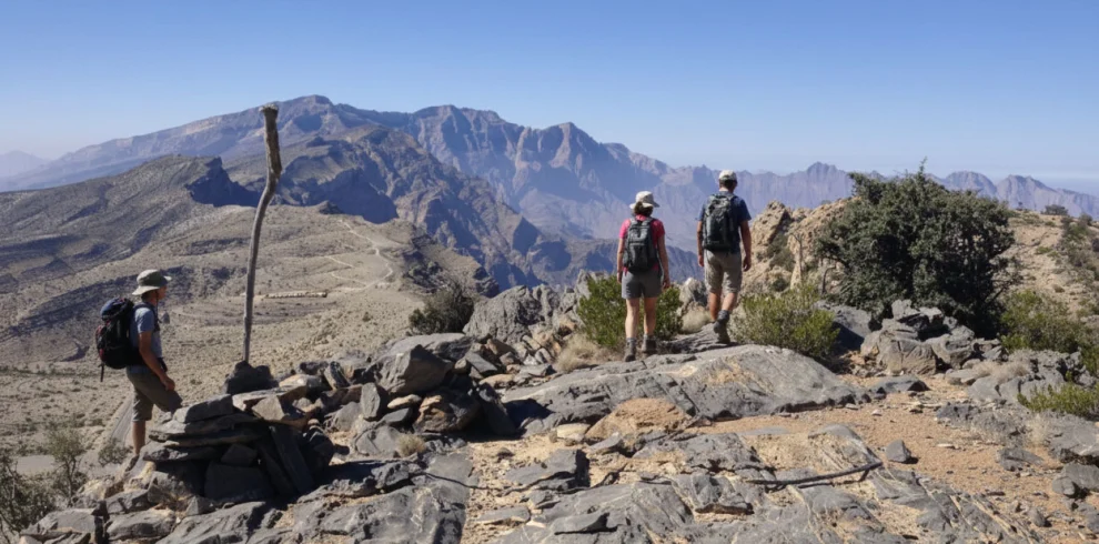 Hikers on a high ridge path among rocks
