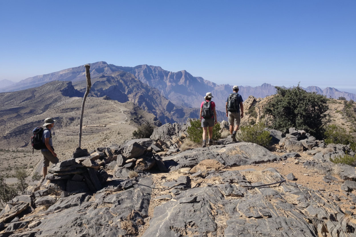 Hikers on a high ridge path among rocks