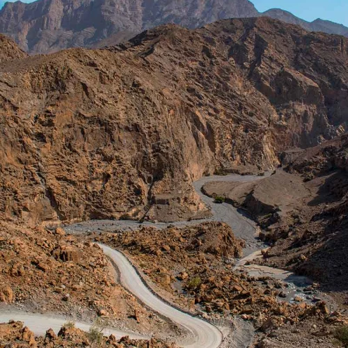 A road winding through a rocky canyon towards Jebel Harim
