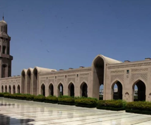 Arcades and a minaret around the courtyard of the Sultan Qaboos Grand Mosque