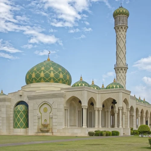 Mosque with green domes and a tall minaret