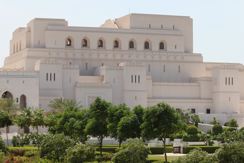 The Royal Opera House Muscat behind trees and lawns