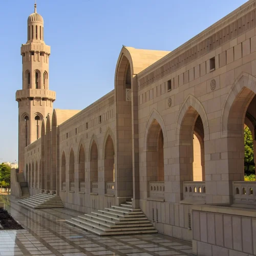 Arched walkway and minaret at the Sultan Qaboos Grand Mosque